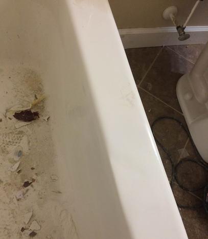 Repaired hole in side of bathtub